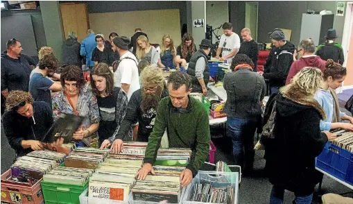  ?? PHOTO: WARWICK SMITH/STUFF ?? Secondhand record sales prove popular with vinyl collectors.