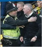  ?? REX ?? Long arm of the law: police try to calm the Ipswich boss