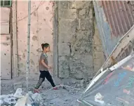  ?? — Reuters ?? DEVASTATED: A girl walks on debris in a rebel-held part of the southern city of Deraa, Syria on Sunday.