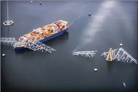  ?? TASOS KATOPODIS — GETTY IMAGES ?? In an aerial view, cargo ship Dali is seen after running into and collapsing the Francis Scott Key Bridge on Tuesday in Baltimore.