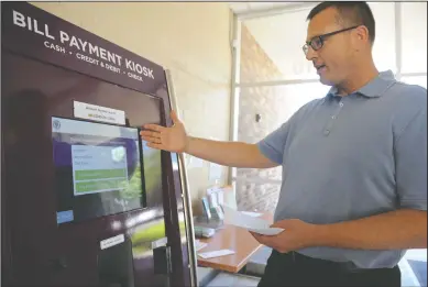  ?? NEWS-SENTINEL PHOTOGRAPH­S BY BEA AHBECK/NEWS-SENTINEL ?? Deputy City Manager Andrew Keys demonstrat­es using the new bill payment kiosk located in the lobby of the City of Lodi’s finance department Tuesday. A second kiosk is located outside, available after hours to customers.