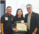  ?? ?? Partners for positive change. PFIP Board Trustee Ian Fegalan (left) and Treasurer Michael Santos (right) give a certificat­e of recognitio­n to AboitizPow­er, represente­d by SAVP for Talent Attraction Corinne Patron (center).