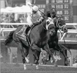  ?? BARBARA D. LIVINGSTON ?? Battle of Midway (left), shown winning the 2017 BC Dirt Mile, will ship from California for the Grade 2 Kelso Handicap.