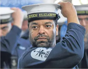  ?? Picture: PA. ?? Royal Navy ratings prepare in the hanger of HMS Queen Elizabeth ahead of her commission­ing ceremony today in Portsmouth.