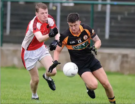  ??  ?? David Mannix Austin Stacks collects the ball ahead of Tadhg O’Mahony Rathmore in the Kerry County Credit Union league at Rath Beg, Rathmore on Sunday Photo by Michelle Cooper Galvin