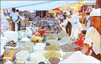  ??  ?? File photo shows Indians buying dry fruits from a roadside vendor at a market in New Delhi. Sentiment is souring in
the country’s boardrooms after a much-anticipate­d budget in July failed to provide any stimulus. (AP)