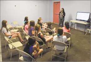  ?? H John Voorhees III / Hearst Connecticu­t Media ?? Courtney Lauria, from the Danbury Woman’s Center, leads a discussion with 6th- to 8th-grade gymnasts about consent. Gymnast Warriors, a group begun by Lauren Candee, of Redding, is acting as a go-between with woman’s centers to talk to gymnasts on Aug. 8 at Gymnastics Revolution in Danbury.