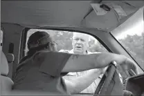  ?? Staff photo by Evan Lewis ?? Little River County Sheriff Gary Gregory talks with a resident of the Richmond Community at a checkpoint Thursday outside of Ashdown, Ark., near where a man went missing in the Red River. The area is closed to the general public, and residents of the...