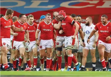  ??  ?? Wales’ players celebrate their victory over England in Cardiff, UK, on Saturday