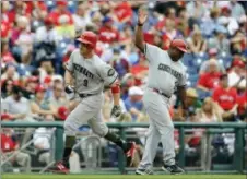  ?? MICHAEL PEREZ — THE ASSOCIATED PRESS ?? Cincinnati’s Patrick Kivlehan (3), being congratula­ted by third base coach Billy Hatcher, ended a recent scoreless stretch by the Phillies bullpen when he belted a solo home run off Jeanmar Gomez in the ninth inning Sunday. The Reds went deep five...