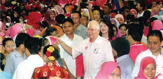  ?? — M. AZHAR ARIF / The Star ?? Warm welcome: Najib shaking hands with youngsters upon his arrival at the Himpunan Wanita Muda Negara 2012 gathering.