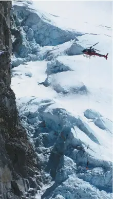  ?? AFP-Yonhap ?? This photograph shows a Nepalese rescue helicopter at the Everest Base Camp, April 18, 2014, as it helps to move an injured climber on a stretcher, bottom center.