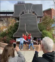  ?? PETE BANNAN-DAILY TIMES ?? Lourdes and Orlando Perez of Miami Florida take photos of their family in front of the Liberty Bell at Citzens Bank Park. Orlando came to the US from Cuba in the 60’s and began cheering for the team because the Phillies had the same colors as his team in Cuba, the Havana Tigers.