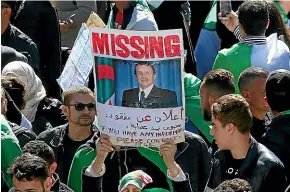  ??  ?? A woman holds a placard depicting Algerian President Abdelaziz Bouteflika during a protest in Algiers yesterday.