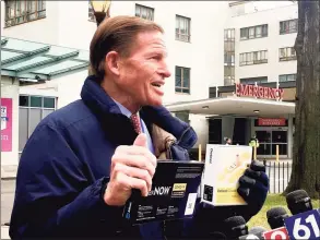  ?? Dan Haar / Hearst Connecticu­t Media ?? Sen. Richard Blumenthal holds two COVID-19 test kits at Hartford Hospital on Monday. The test in his left hand was made in Guilford by Detect, Inc.
