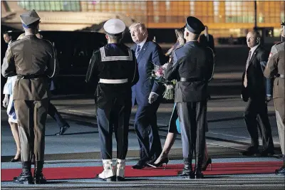  ?? [EVAN VUCCI/THE ASSOCIATED PRESS] ?? President Donald Trump and first lady Melania Trump walk to their vehicle after arriving Wednesday at Warsaw’s Chopin Airport.