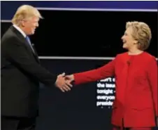  ?? DAVID GOLDMAN ‑ THE ASSOCIATED PRESS ?? In this 2016 photo, Republican presidenti­al nominee Donald Trump and Democratic presidenti­al nominee Hillary Clinton shake hands during the presidenti­al debate at Hofstra University in Hempstead, N.Y. Months after her defeat in the election some have...