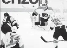  ?? GENE J. PUSKAR
THE ASSOCIATED PRESS ?? Penguins’ Derick Brassard fires a shot past Philadelph­ia Flyers goalie Alex Lyon for a goal in Pittsburgh on Sunday. The Penguins won, 5-4.