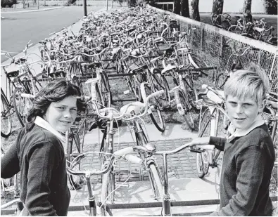  ?? PHOTO: OTAGO DAILY TIMES FILES ?? A sea of bicycles was a schoolday scene at Mosgiel Intermedia­te School, in Green St, in February 1981. This collection was less than half the number of bicycles ridden to the school by the pupils. About to extract their bikes from the tangle are Jan Dunbar and Raymond Miller.