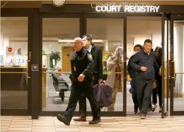  ??  ?? People are escorted out of the court registry by a BC sheriff after the BC Supreme Court bail hearing of Huawei CFO Meng Wanzhou, who was released on a C$10 million bail in Vancouver, British Columbia, Canada. – Reuters photo