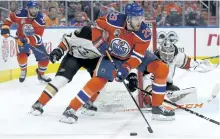  ?? DAVID BLOOM/POSTMEDIA NETWORK ?? Edmonton Oilers’ forward Leon Draisaitl battles the Anaheim Ducks’ Rickard Rakell during Game 3 on Sunday, at Rogers Place, in Edmonton.