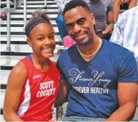  ?? LEXINGTON HERALD-LEADER FILE PHOTO ?? In this photo from May 3, 2014, Trinity Gay poses as a seventh-grade sprinter with her Olympian father, Tyson Gay, after she won the 100 meters and was part of two winning relays at the meet in Georgetown, Ky.