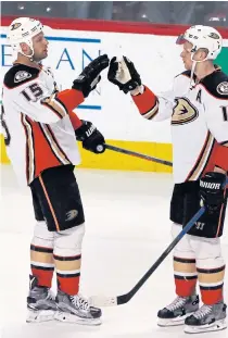  ??  ?? Ducks right wing Corey Perry, right, celebrates with Ryan Getzlaf.