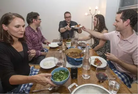  ?? BERNARD WEIL/TORONTO STAR ?? Tech entreprene­urs, from left, April Dunford, David Crow, Johnathan Nightingal­e, Melissa Shapiro and Ryan Merkley share dinner at Corey Mintz’s place..