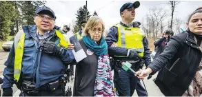  ?? (FRANCIS GEORGIAN / PNG) ?? Elizabeth May being arrested by RCMP. May, the MP for Saanich Gulf Islands, and Burnaby South MP Kennedy Stewart took action on March 23, 2018 at Kinder Morgan’s Burnaby Mountain constructi­on site.