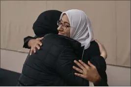  ?? ANDRES KUDACKI — THE ASSOCIATED PRESS ?? Two women hug as Muslim and Jewish women gather at an interfaith workshop on the Israeli-Palestinia­n conflict at Rutgers University on Nov. 19in New Brunswick, N.J.