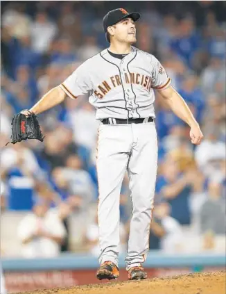  ?? Gary Coronado Los Angeles Times ?? ONE PITCH away from a no-hitter, Matt Moore of the Giants reacts after his 133rd delivery of the game is hit into right field for a single by Corey Seager of the Dodgers.