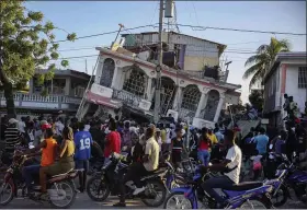  ?? JOSEPH ODELYN — THE ASSOCIATED PRESS ?? People gather Aug. 14outside the Petit Pas Hotel, destroyed by the earthquake in Les Cayes, Haiti. A 7.2magnitude earthquake struck Haiti on Saturday, with the epicenter about 78miles west of the capital of Port-au-Prince, the US Geological Survey said.