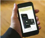  ?? PETER MORGAN/AP 2022 ?? A text at the top of this phone’s screen announces BlockFi’s filing for bankruptcy protection.