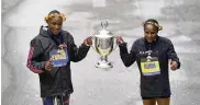  ?? CHARLES KRUPA / ASSOCIATED PRESS ?? Evans Chebet, left, and Hellen Obiri, both of Kenya, pose on the finish line after winning the men’s and women’s division of the Boston Marathon, Monday in Boston.