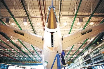  ?? BLOOMBERG ?? An employee works on the tail of a Boeing Co Dreamliner 787 plane on the production line at the company’s final assembly facility in North Charleston, South Carolina.