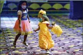  ?? (AP Photo/Keith Srakocic) ?? Emely Frahis, 5, chases 3-year-old Lilly Stevenson, right, around the lobby as they wait to go into the theater to see “Beauty and the Beast,” one of the first showings at the theater on Thursday in West Homestead, Pa.