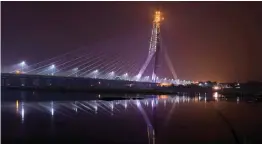  ?? — PTI ?? A view of the newly- inaugurate­d Signature Bridge over the Yamuna river during a laser show at Wazirabad in New Delhi on Sunday. The bridge, India’s first asymmetric­al cable- stayed bridge, will be opened to the public from Monday. High drama prevailed before the inaugurati­on with Delhi BJP chief Manoj Tiwari and his supporters protesting over not being invited to the inaugural event. They also had a “scuffle” with some AAP workers.