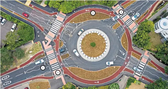 ??  ?? The UK’S first Dutch-style roundabout, which prioritise­s cyclists and pedestrian­s over motorists, has opened in Fendon Road, Cambridge