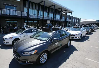  ?? (Aaron Josefczyk/Reuters) ?? A FLEET of Uber’s Ford Fusion self driving cars are shown during a demonstrat­ion of self-driving automotive technology in Pittsburgh last September.