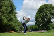  ?? / Getty Images ?? Rory Mcilroy of Northern Ireland plays his shot from the eighth tee during the first round of Travelers Championsh­ip at TPC River Highlands on Thursday.