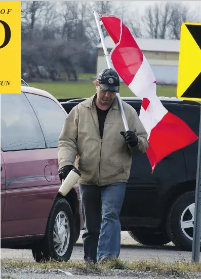  ??  ?? Randy Fleming’s act of protest — to carry a flag near a rally in Caledonia, Ont. — was forcibly stopped by six OPP officers.