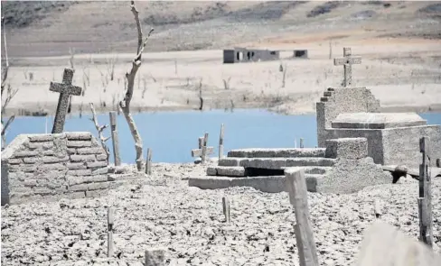  ??  ?? >Ante la escasez de agua en la presa Gustavo Díaz Ordaz, el panteón de Terahuito emergió.