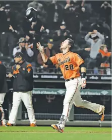  ?? Marcio Jose Sanchez / Associated Press ?? Buster Posey tosses his helmet as he approaches home plate after his 17th-inning home run ended the game at 12:43 a.m.