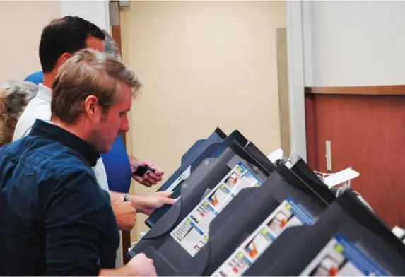  ?? (Photo by Brad Robertson, SDN) ?? Election Commission­er Jason Hauser tests voting machines.