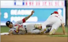  ?? MATT SLOCUM — THE ASSOCIATED PRESS ?? St. Louis’ Yairo Munoz, left, is tagged out at second by Phillies shortstop Scott Kingery after Munoz tried to steal during the fourth inning Tuesday.