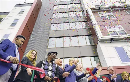  ?? Photos from Albany Times Union ?? Elected officials and community leaders celebrate at the 2019 ribbon-cutting for affordable housing at 280 North in Albany. 280 North is the second phase of the redevelopm­ent of the site where the original Ida Yarbrough Homes complex once stood.