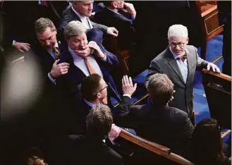  ?? Jabin Botsford / The Washington Post ?? Mike Rogers (R-Ala.) is restrained after getting into an argument with Matt Gaetz (R-Fla.) during in the 14th round of voting for speaker.
