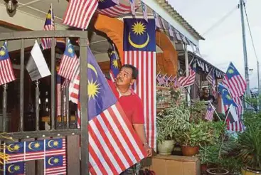  ??  ?? MD Amin menghias rumahnya dengan Jalur Gemilang.