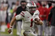  ?? CHRIS O’MEARA - THE ASSOCIATED PRESS ?? FILE - In this Monday, Jan. 11, 2021 file photo, Ohio State quarterbac­k Justin Fields runs against Alabama during the second half of an NCAA College Football Playoff national championsh­ip game in Miami Gardens, Fla.