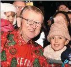  ??  ?? Cllr Donal Grady giving out sweets at the Christmas in Killarney Parade on Saturday.